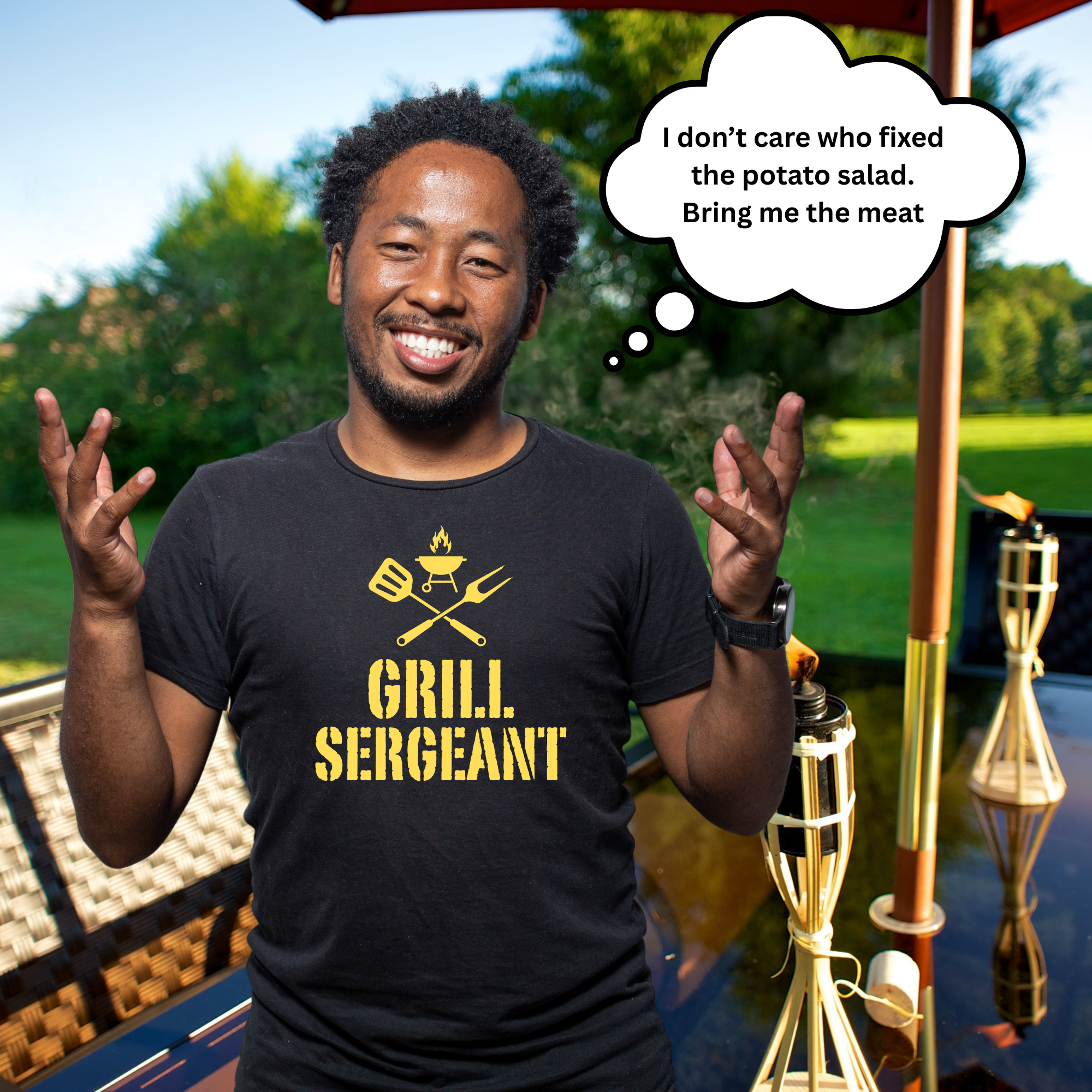 Man wearing a 'Grill Sergeant' shirt with a thought bubble about potato salad and meat, outdoors.